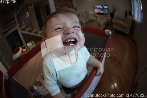 Image of cute little baby playing in mobile bed