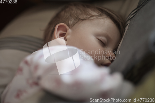 Image of newborn baby sleeping at home in bed