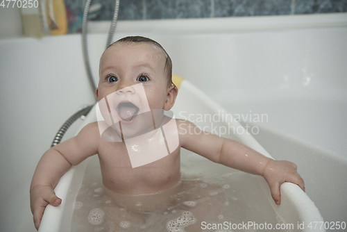 Image of cute little baby girl taking a bath