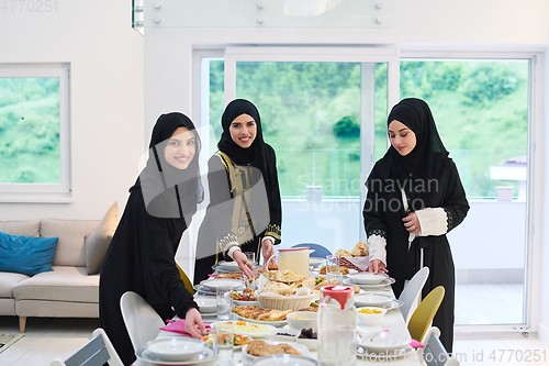 Image of Young muslim women preparing food for iftar during Ramadan