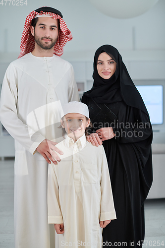 Image of Portrait of young arabian muslim family wearing traditional clothes