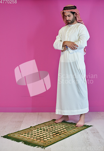 Image of Young muslim man praying salat during Ramadan