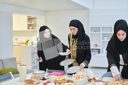 Image of Young muslim women preparing food for iftar during Ramadan