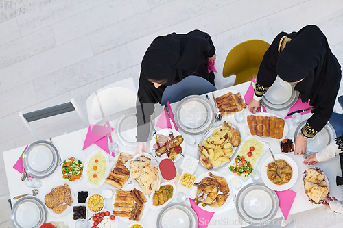 Image of Top view of young muslim women preparing food for iftar during Ramadan