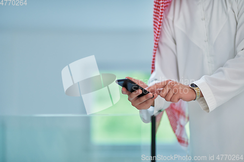 Image of Portrait of young muslim businessman using mobile phone