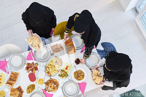 Image of Top view of young muslim women preparing food for iftar during Ramadan