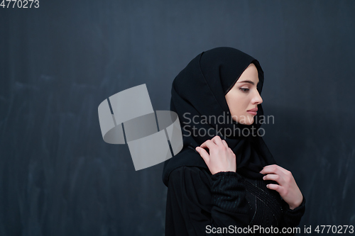 Image of Modern young muslim woman in black abaya