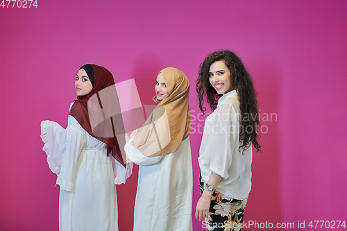 Image of Young muslim women posing on pink background