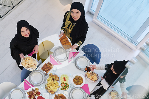 Image of Top view of young muslim women preparing food for iftar during Ramadan