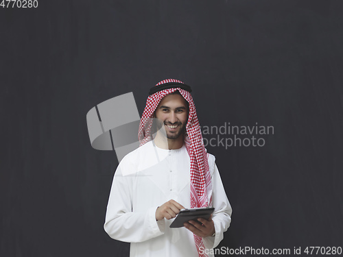 Image of Portrait of young muslim businessman using tablet