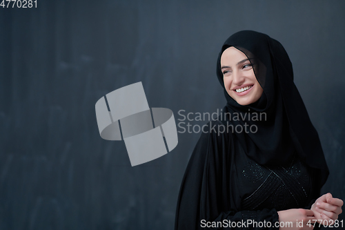 Image of Modern young muslim woman in black abaya