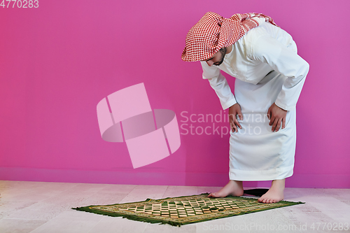 Image of Young muslim man praying salat during Ramadan