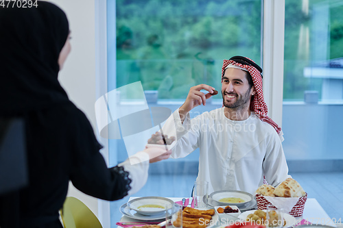 Image of Muslim couple sharing dates for starting iftar