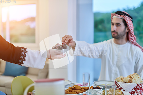 Image of Muslim couple sharing dates for starting iftar