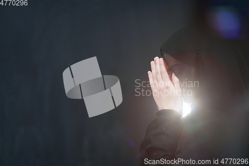 Image of Portrait of young Muslim woman making dua