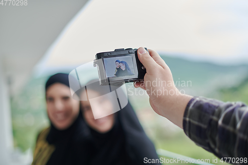 Image of Portrait of young muslim women on the balcony