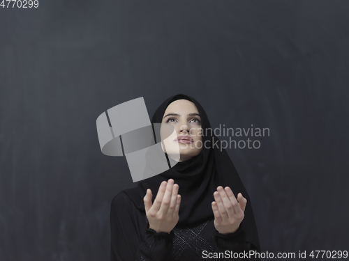 Image of Portrait of young Muslim woman making dua