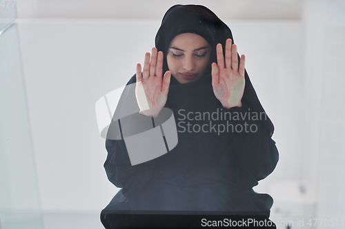 Image of Young muslim woman doing sujud or sajdah