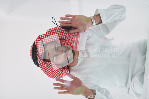 Image of Muslim man doing sujud or sajdah on the glass floor