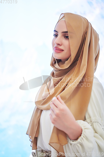 Image of Girl wearing hijab posing on winter concept background