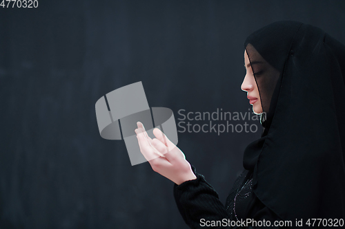 Image of Portrait of young Muslim woman making dua