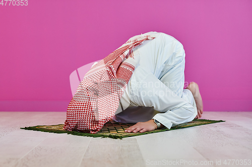 Image of Young muslim man praying salat during Ramadan