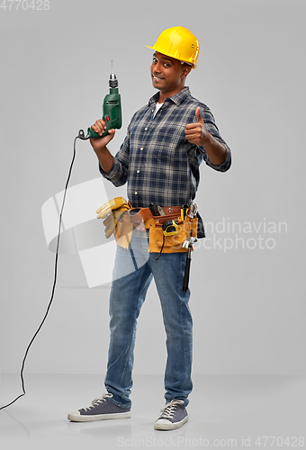 Image of happy indian builder in helmet with electric drill