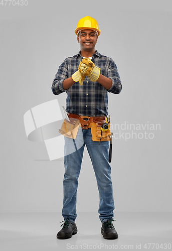 Image of indian worker or builder in helmet and gloves