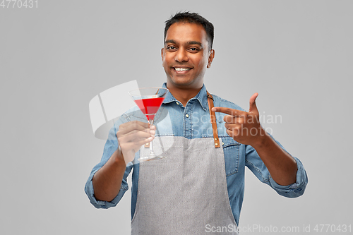 Image of indian barman in apron with glass of cocktail