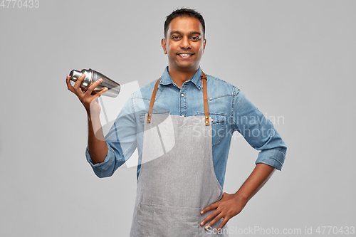 Image of indian barman in apron with cocktail shaker