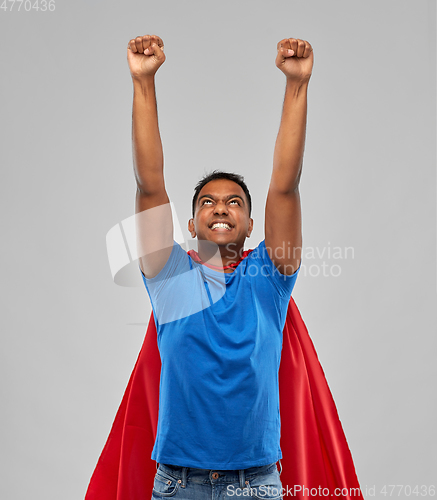 Image of indian man in superhero cape makes winning gesture