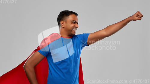 Image of indian man in superhero cape makes winning gesture