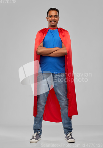 Image of indian man in red superhero cape with arms crossed