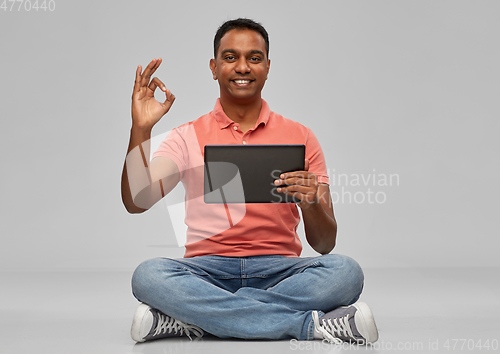 Image of happy indian man with tablet pc