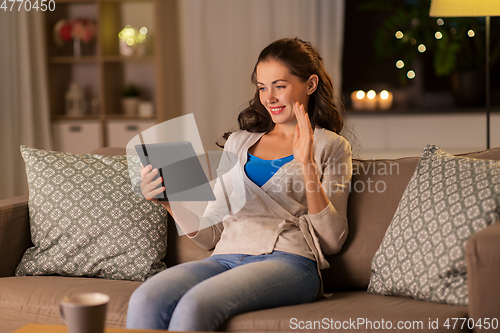 Image of woman with tablet pc having video call at home