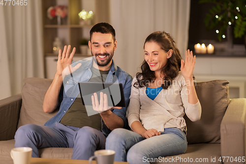 Image of couple with tablet pc having video call at home