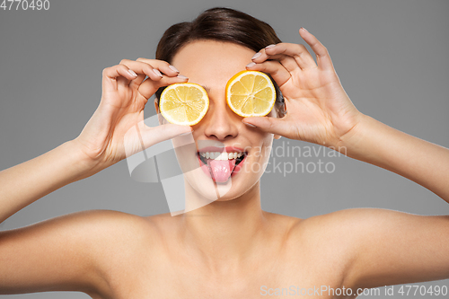 Image of beautiful woman making eye mask of lemon slices