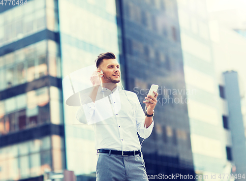 Image of man with headphones and smartphone listening music