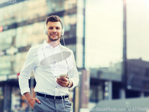 Image of man with headphones and smartphone listening music