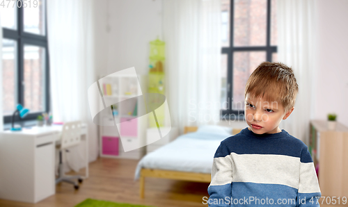 Image of portrait of gloomy little boy at home