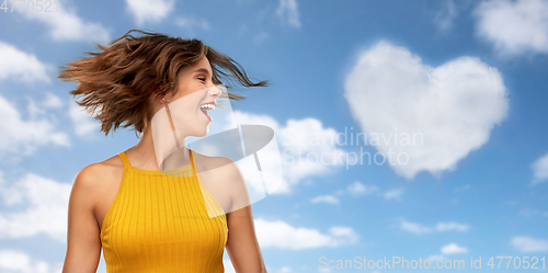 Image of happy young woman shaking head