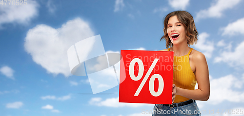 Image of happy smiling young woman with sale signs