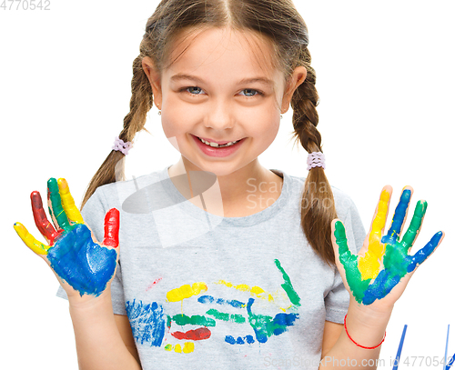 Image of Portrait of a cute girl playing with paints