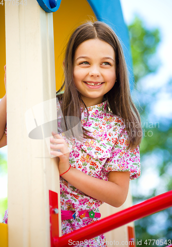Image of Cute little girl is playing in playground