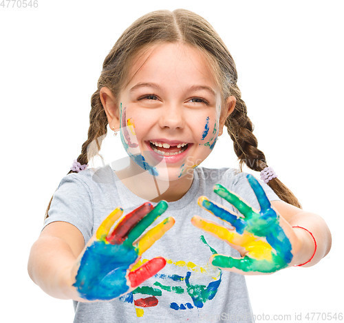 Image of Portrait of a cute girl playing with paints