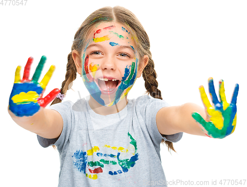 Image of Portrait of a cute girl playing with paints