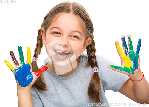 Image of Portrait of a cute girl playing with paints