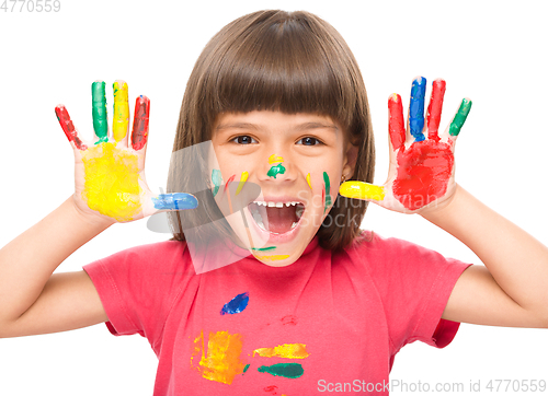 Image of Portrait of a cute girl playing with paints