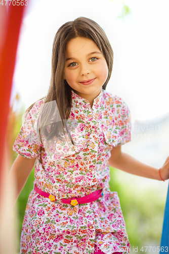 Image of Cute little girl is playing in playground