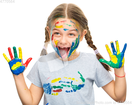 Image of Portrait of a cute girl playing with paints